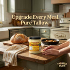 Fresh baked bread loaf and a skillet beside Farmer Bob's beef tallow on a kitchen counter